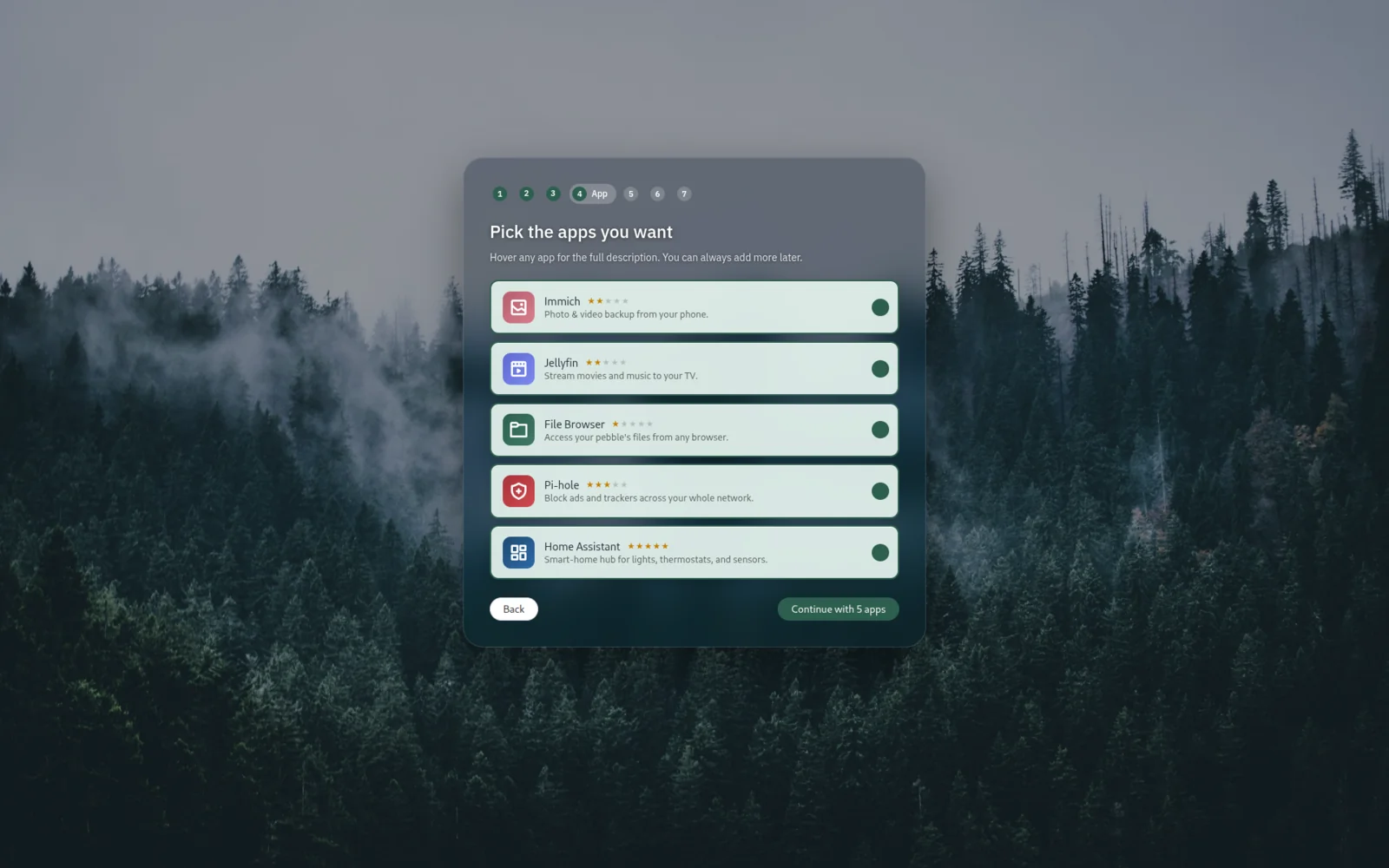 Welcome wizard step asking 'Pick the apps you want' with a list including Immich, Jellyfin, File Browser, Pi-hole, and Home Assistant.
